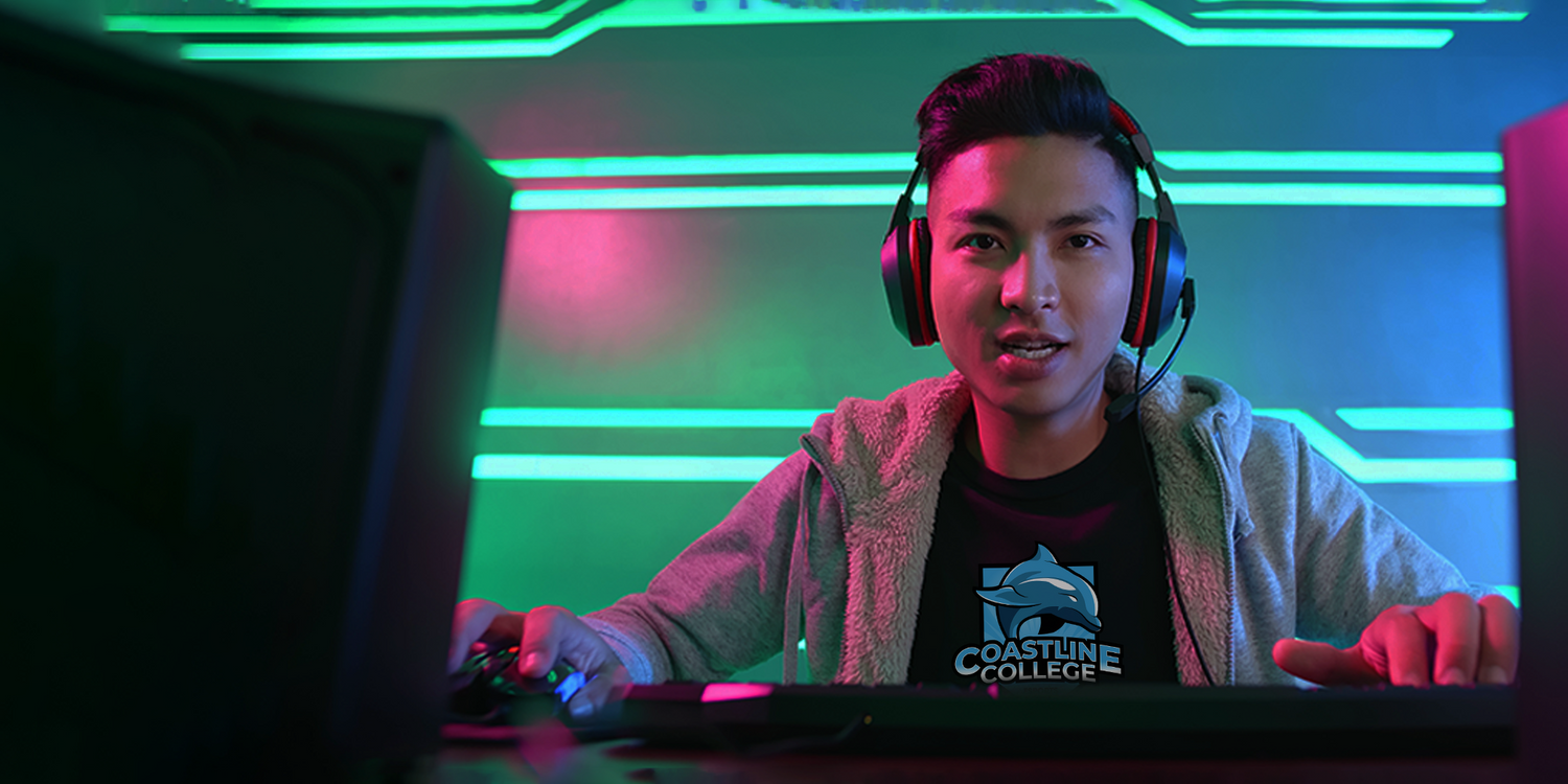 young male gamer wearing headphones and engaged in a game
